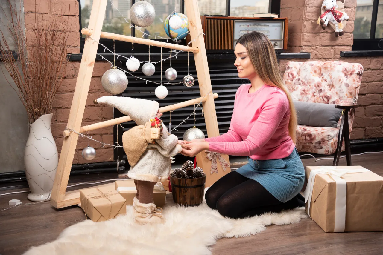 beautiful young woman playing with doll home