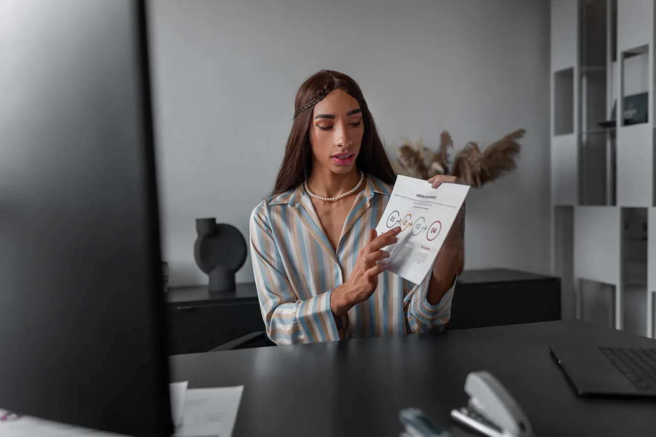 medium shot queer model working office