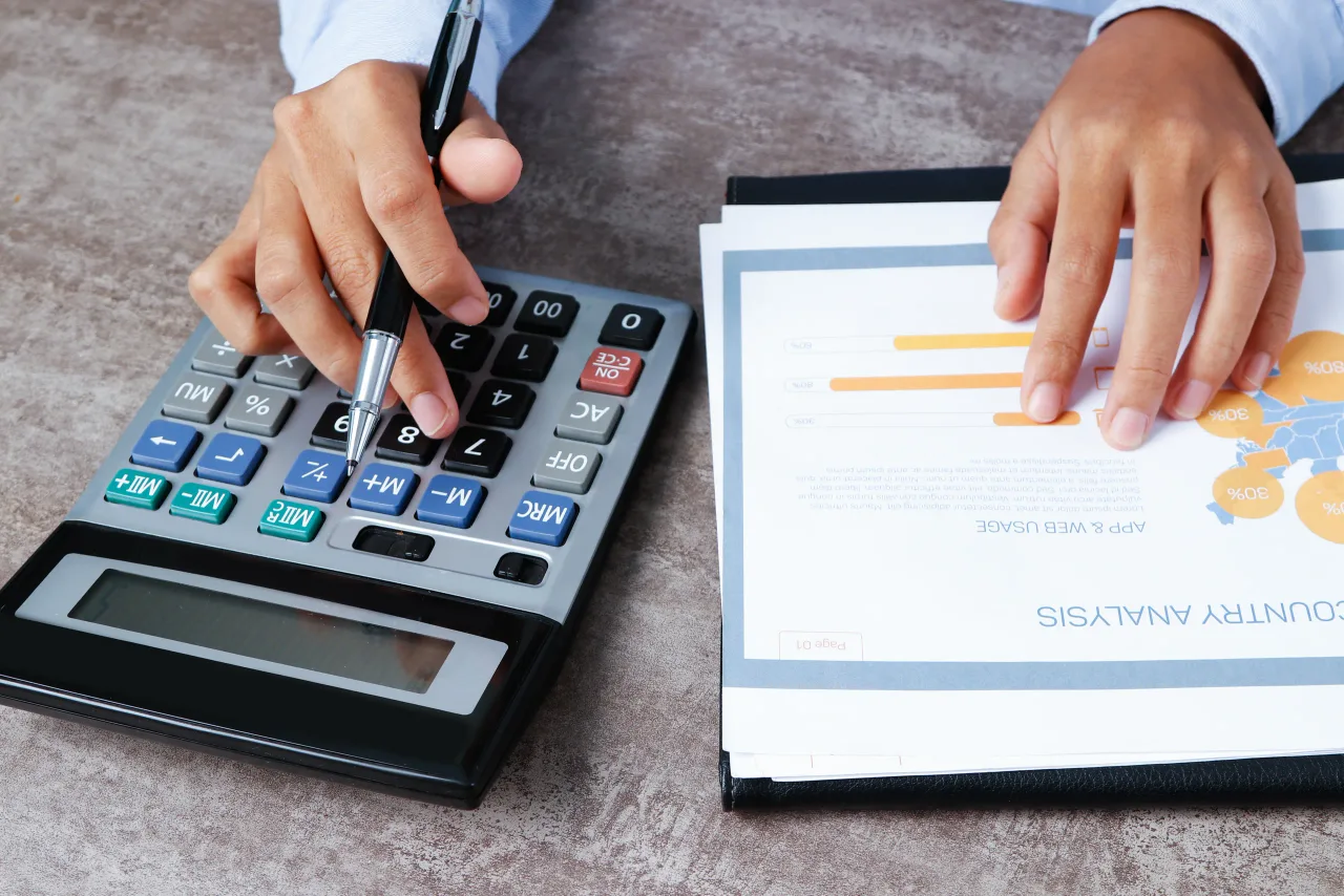 closeup analyst using calculator