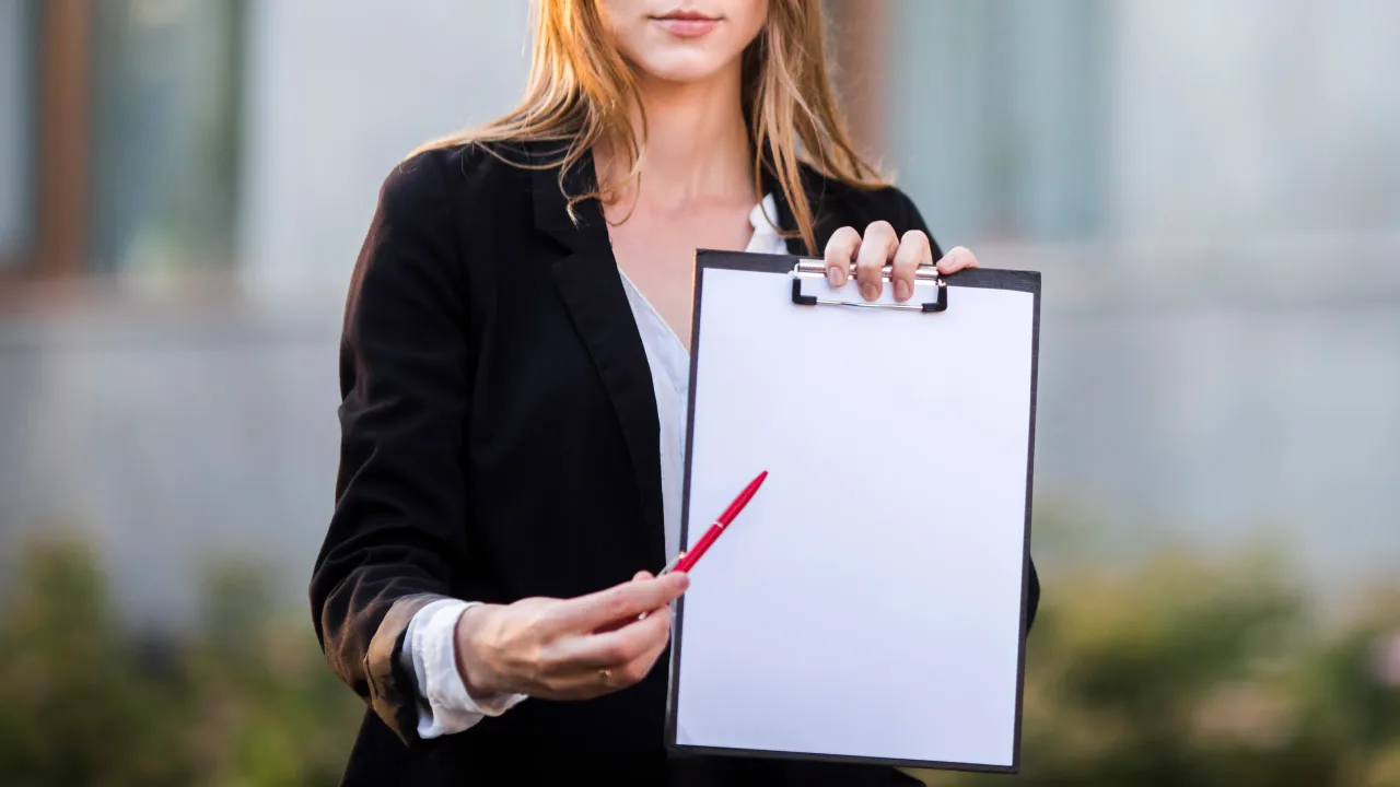 businesswoman pointing clipboard with copy space
