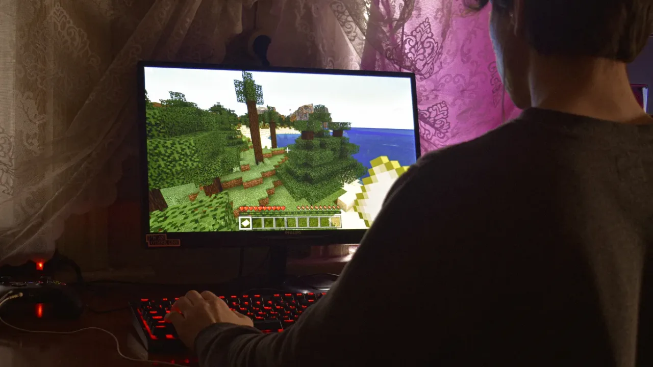 Player exploring a block-style landscape on a desktop computer, showcasing an Open World Game.