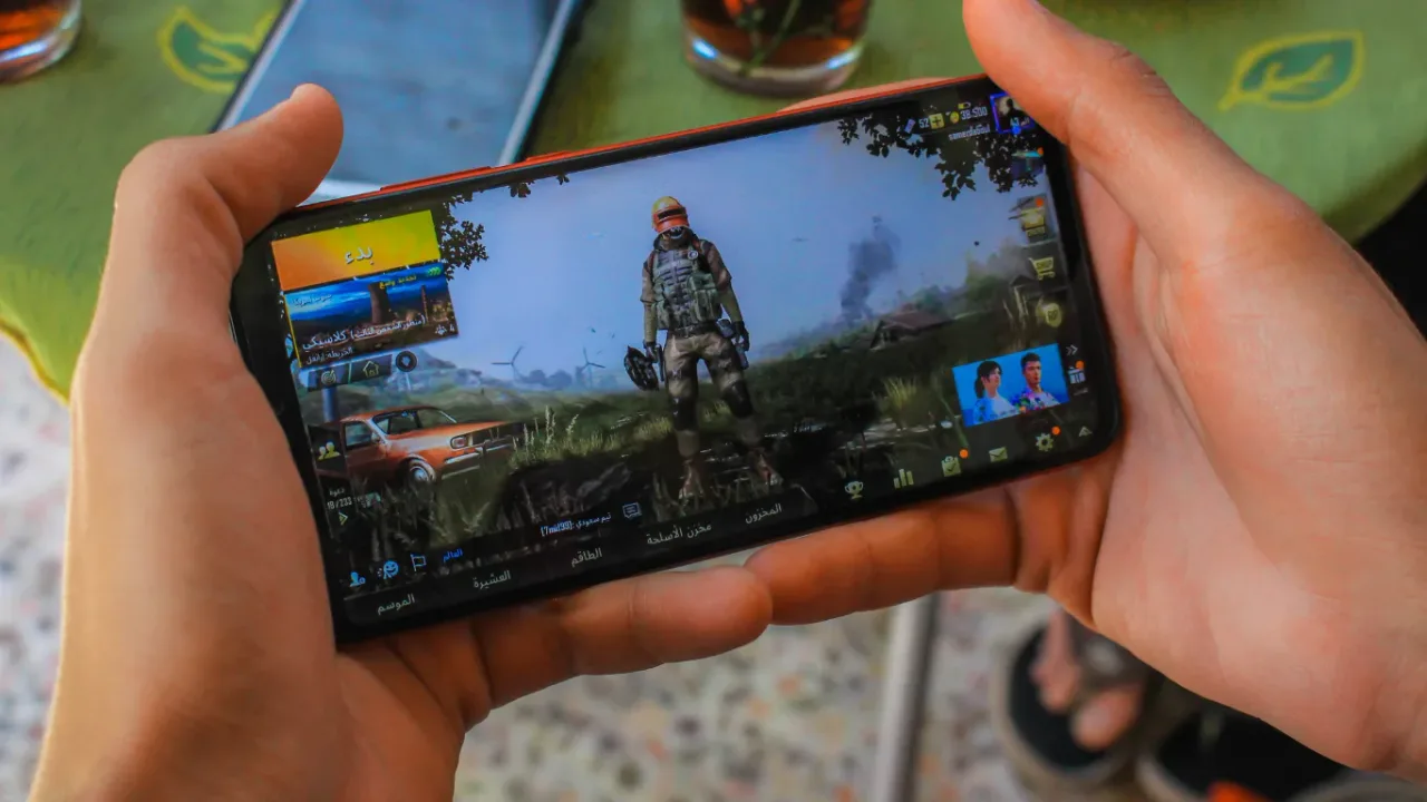 Game Modding Basics illustrated on a smartphone displaying a mobile game interface, highlighting the fundamentals of game customization and modding.