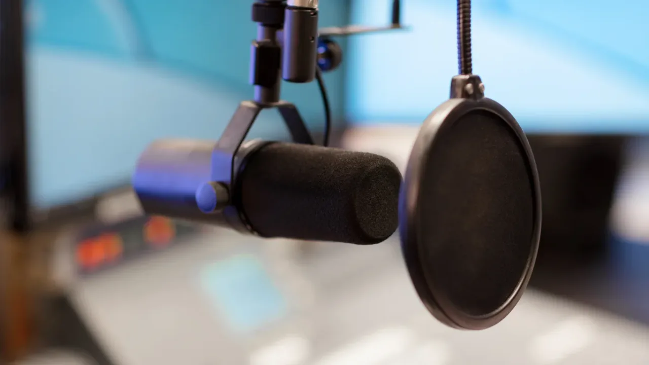 Professional broadcast microphone with a pop filter in a recording studio, symbolizing Broadcasting Rights and media production.