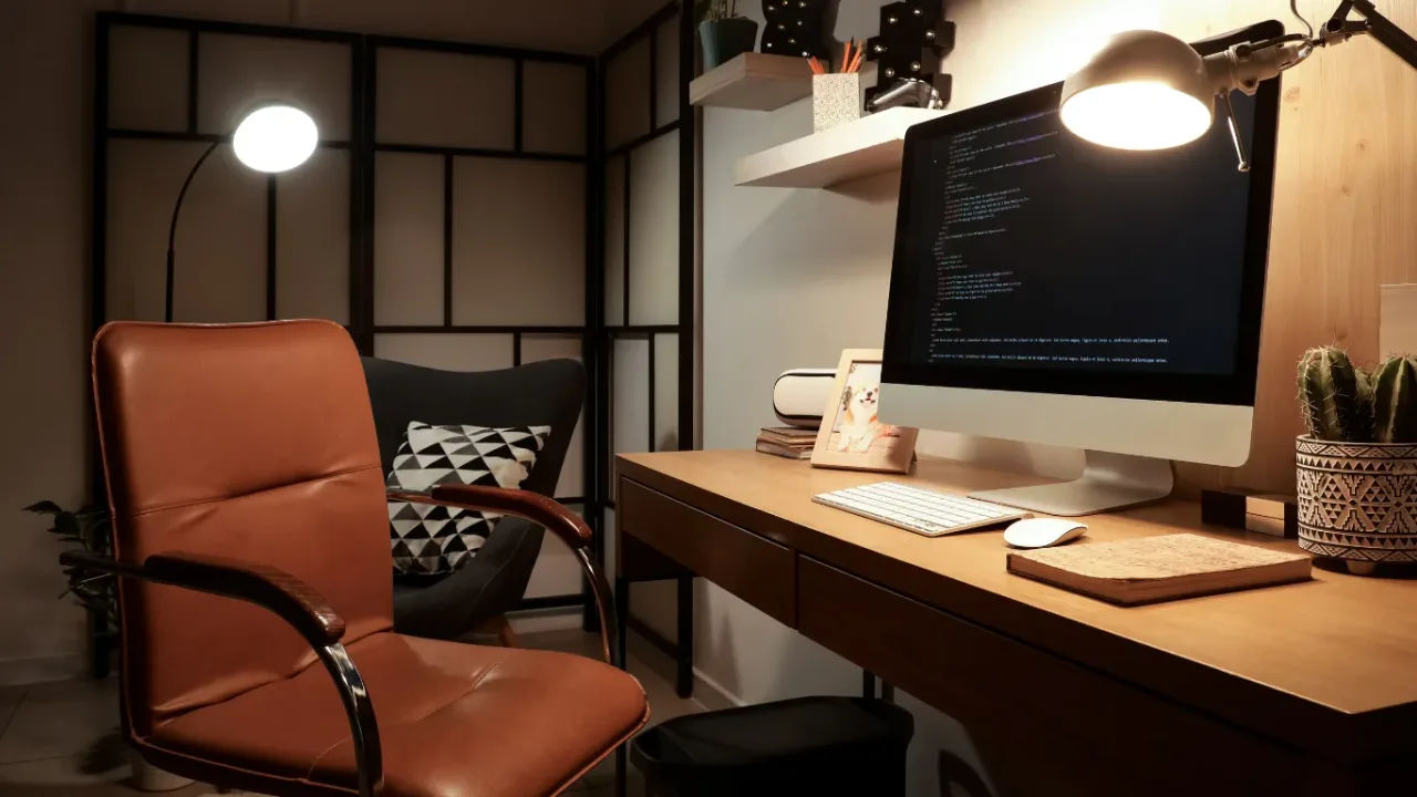 Modern home office with a computer displaying code, representing Remote Development.