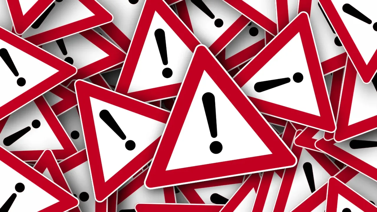 Multiple warning signs illustrating a Content Warning System for digital platforms and online safety.