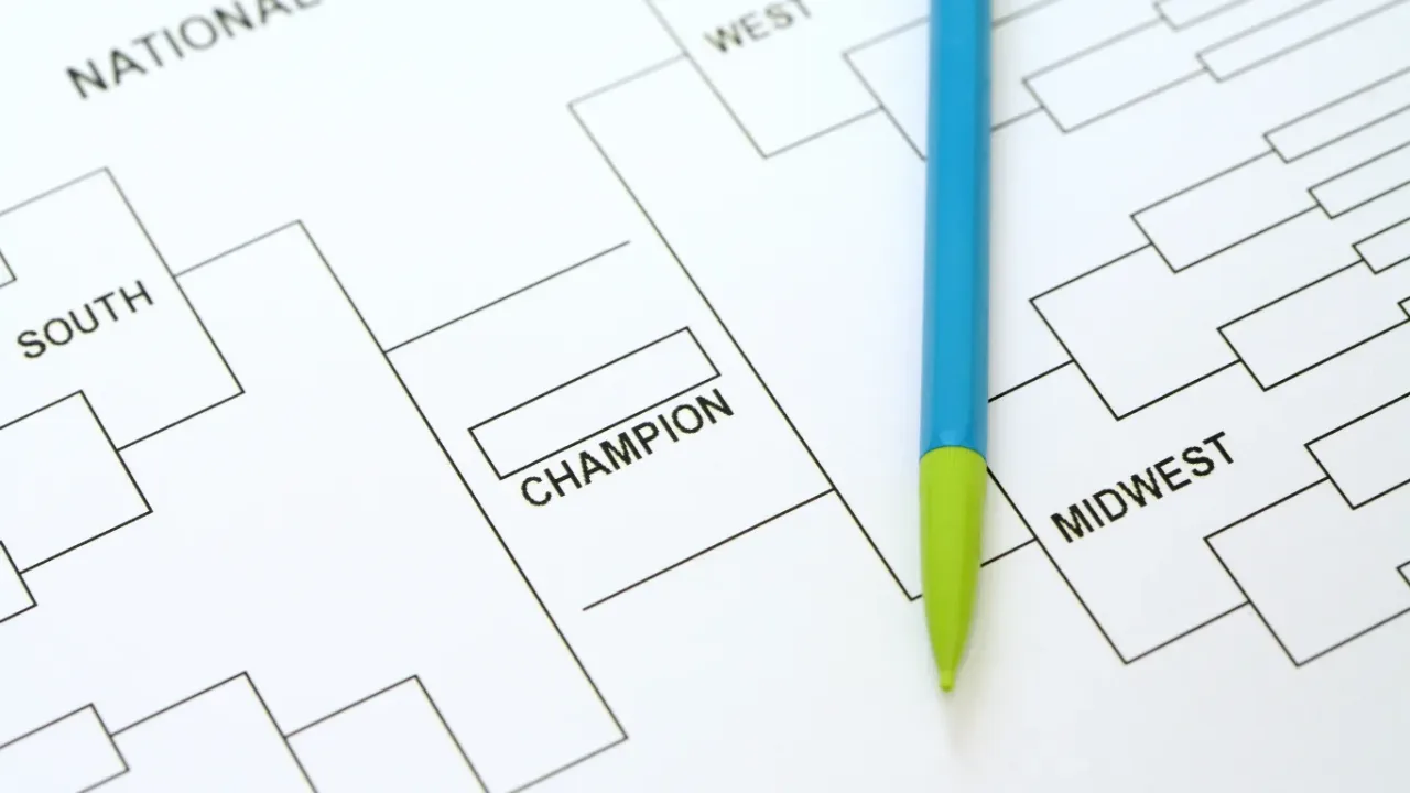 Multi-Game Tournament Format illustrated by a championship bracket with a pen positioned over the matchups.