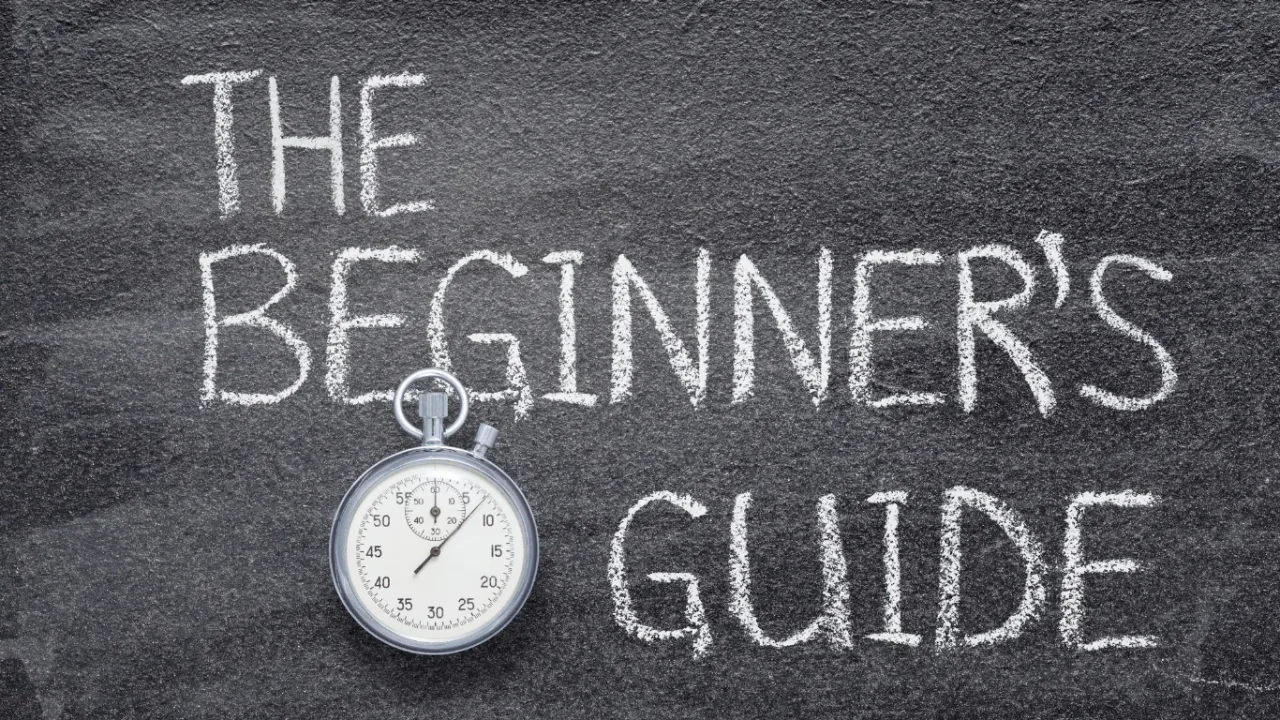 Chalkboard displaying “The Beginner’s Guide” with a stopwatch, representing an Esports Beginner Guide for newcomers learning the basics of competitive gaming.