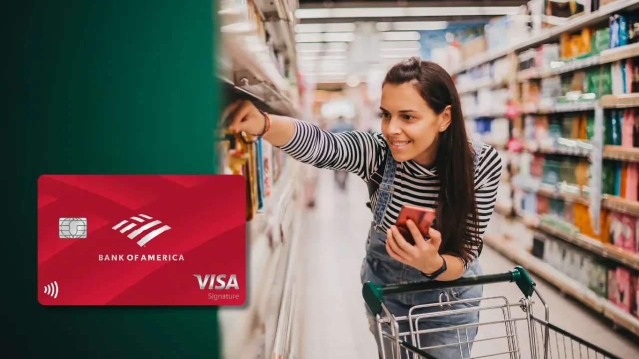 Bank of America Customized Cash Rewards credit card next to a smiling woman holding her phone while picking products from a supermarket shelf with a shopping cart.