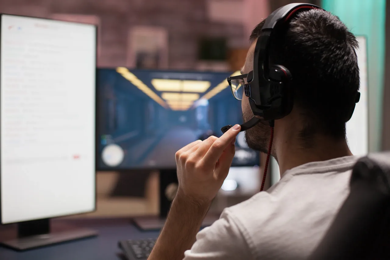 man playing shooter games with other players late night streaming esports competition