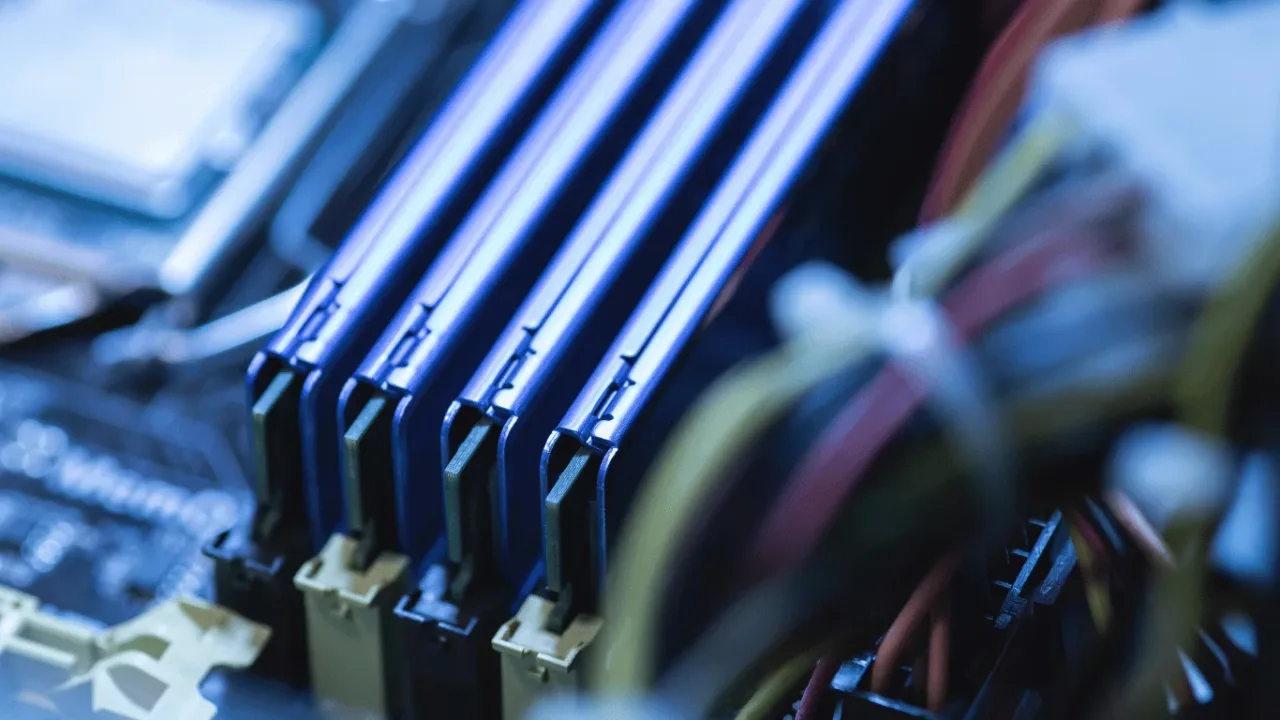 Close-up of blue RAM modules on a motherboard, illustrating key steps from our RAM Upgrade Guide for Improved Game Performance for a faster, smoother setup.