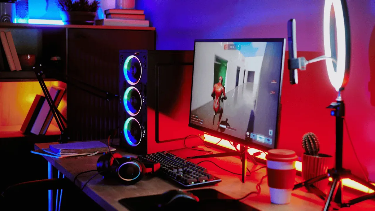 A vibrant gamer's desk with PC, peripherals, and ring light, perfectly illustrating the essential Streaming Setup Basics for New Content Creators.